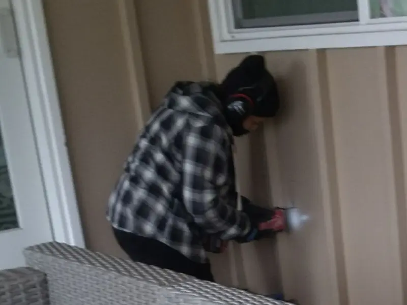 Professional electrician installing an exterior outlet in Unity